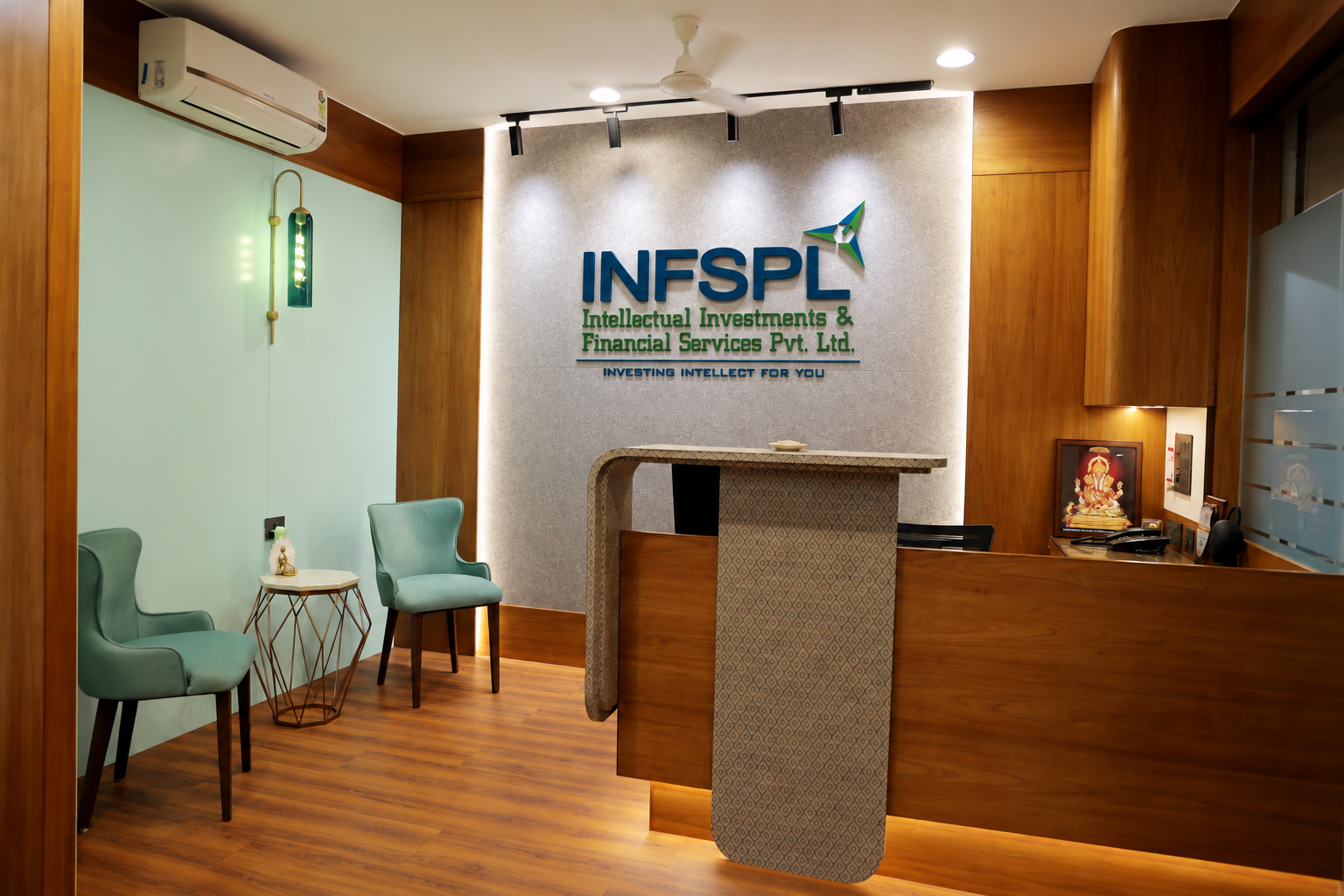 INFSPL office reception with branded wall, wooden desk and seating area